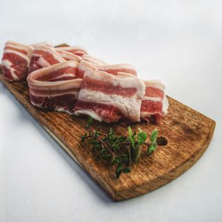 Food photography of sliced bacon on top of brown chopping 1927377